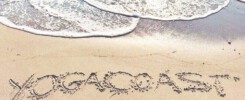 Impressum. Yogacoast mit Schriftzug in den Sand geschrieben